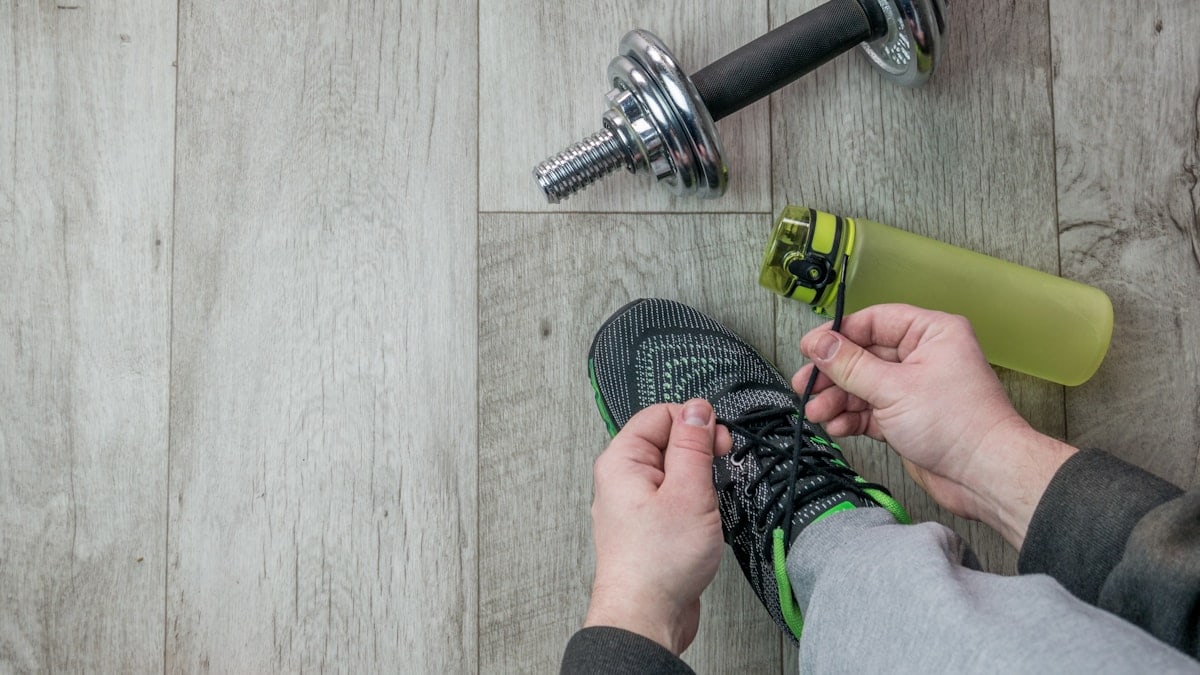 Fitness objects isolated on wooden background. Gray Sneakers, dumbbells and water bottle. Active, healthy lifestyle, sport, fitness, and objects concept. More of my photos and videos Adobe Stock:http://bit.ly/3RqlciK More of my photos and videos Shutterstock: https://www.shutterstock.com/g/ALEKSANDRBERDYUGIN My email: bermix999@gmail.com